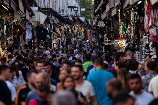 (FILES) Customers shop at a bazaar in Istanbul on September 6, 2022, as Turkey's economy is suffering its biggest economic crisis in decades ahead of one of the toughest elections of President Recep Tayyip Erdogan's rule. Turkey's annual inflation slowed in November to 31.1 percent, down from 32.87 percent in October, its lowest in four years, official data showed on December 3, 2025. (Photo by Yasin AKGUL / AFP)