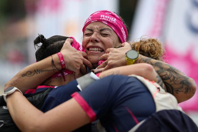 TOPSHOT - Team Les Licornes des Alizés' Audrey Ruoppolo reacts with her teammates as they cross the finish line of the "Raid des Alizes", an exclusively all-female multi sport competition on the French Caribbean island of Martinique, on November 29, 2025. The all-female event features running, mountain biking, kayaking, and trekking events with each team representing a charity project of their choice with the overall ranking determining the prize money which will be directly donated to the charities. (Photo by Anne-Christine POUJOULAT / AFP)
