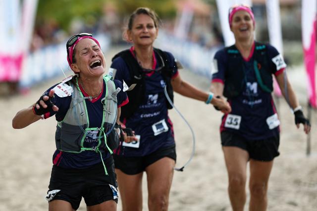 Competitors of team Pli Bel La Vi react as they cross the finish line of the "Raid des Alizes", an exclusively all-female multi sport competition on the French Caribbean island of Martinique, on November 29, 2025. The all-female event features running, mountain biking, kayaking, and trekking events with each team representing a charity project of their choice with the overall ranking determining the prize money which will be directly donated to the charities. (Photo by Anne-Christine POUJOULAT / AFP)