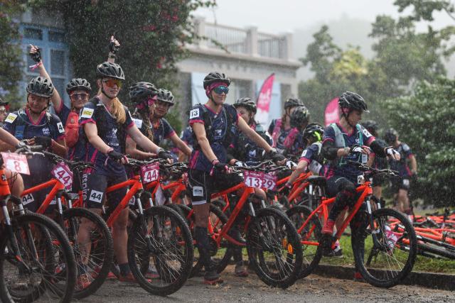Competitors wait the start of the Mountain bike race of the "Raid des Alizes", an exclusively all-female multi sport competition, at the Chateau Depaz on the French Caribbean island of Martinique, on November 27, 2025. The all-female event features running, mountain biking, kayaking, and trekking events with each team representing a charity project of their choice with the overall ranking determining the prize money which will be directly donated to the charities. (Photo by Anne-Christine POUJOULAT / AFP)