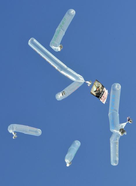 (FILES) Large balloons carrying anti-Pyongyang leaflets are released by former North Korean defectors living in South Korea at Imjingak park near the inter-Korean border in Paju on February 16, 2013. South Korea has passed a law banning unmanned balloons from no-fly zones, Seoul's unification ministry said December 3, 2025, in a move expected to curb activists from flying anti-Pyongyang leaflets across the border. (Photo by Jung Yeon-je / AFP)