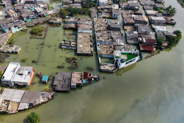 An aerial view shows houses partially submerged in floodwaters following heavy rainfall in the aftermath of Cyclone Ditwah in Wellampitiya on the outskirts of Colombo on December 3, 2025. (Photo by AFP)
