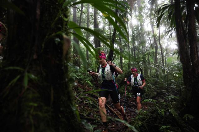 Members of team "Soeuraid" compete in a trail race on the Montagne Pelee as part of the "Raid des Alizes", an exclusively all-female multi sport competition, on the French Caribbean island of Martinique, on November 28, 2025. The all-female event features running, mountain biking, kayaking, and trekking events with each team representing a charity project of their choice, with the overall ranking determining the prize money which will be directly donated to the charities. (Photo by Anne-Christine POUJOULAT / AFP)