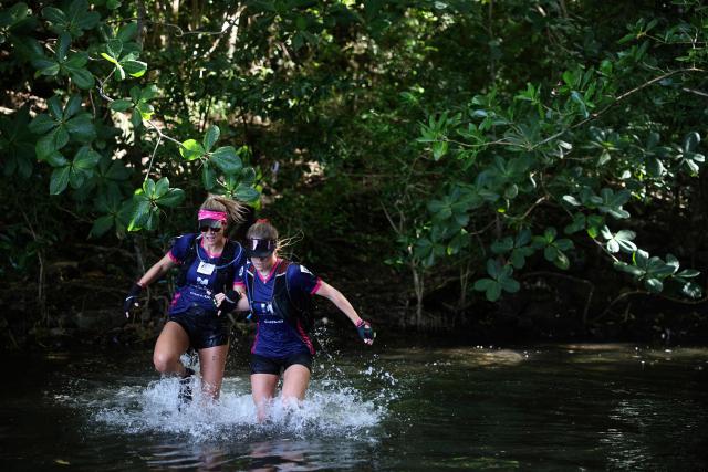 Alexandra Elize and Louana Roy of team "All Amazones" compete in a trail race as part of the "Raid des Alizes", an exclusively all-female multi sport competition, on the French Caribbean island of Martinique, on November 29, 2025. The all-female event features running, mountain biking, kayaking, and trekking events with each team representing a charity project of their choice, with the overall ranking determining the prize money which will be directly donated to the charities. (Photo by Anne-Christine POUJOULAT / AFP)