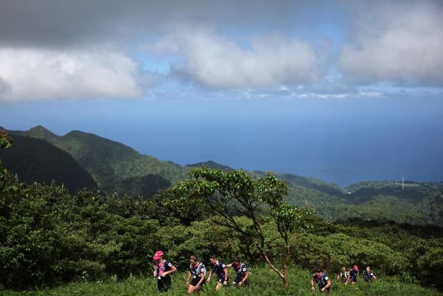 Competitors take part in a trail race on the Montagne Pelee as part of the "Raid des Alizes", an exclusively all-female multi sport competition, on the French Caribbean island of Martinique, on November 28, 2025. The all-female event features running, mountain biking, kayaking, and trekking events with each team representing a charity project of their choice, with the overall ranking determining the prize money which will be directly donated to the charities. (Photo by Anne-Christine POUJOULAT / AFP)