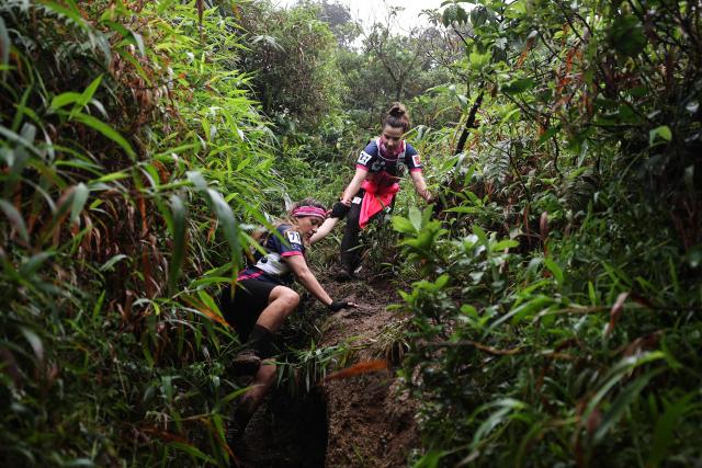 Members of team "Les Pawer Girls" compete in a trail race on the Montagne Pelee as part of the "Raid des Alizes", an exclusively all-female multi sport competition, on the French Caribbean island of Martinique, on November 28, 2025. The all-female event features running, mountain biking, kayaking, and trekking events with each team representing a charity project of their choice, with the overall ranking determining the prize money which will be directly donated to the charities. (Photo by Anne-Christine POUJOULAT / AFP)