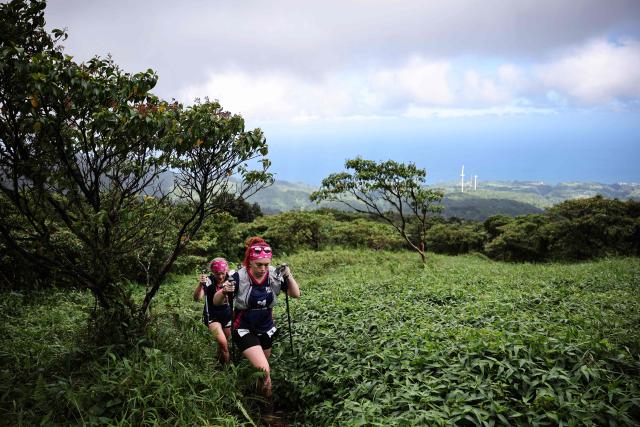Competitors take part in a trail race on the Montagne Pelee as part of the "Raid des Alizes", an exclusively all-female multi sport competition, on the French Caribbean island of Martinique, on November 28, 2025. The all-female event features running, mountain biking, kayaking, and trekking events with each team representing a charity project of their choice, with the overall ranking determining the prize money which will be directly donated to the charities. (Photo by Anne-Christine POUJOULAT / AFP)
