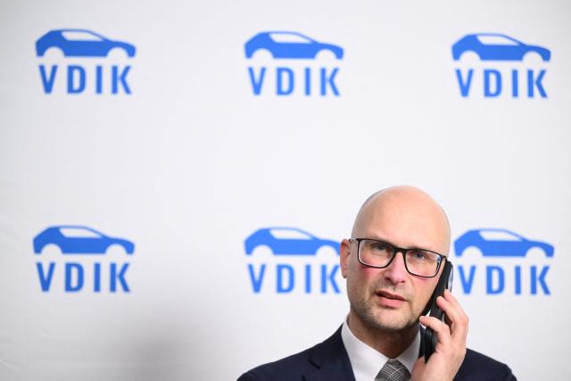 German Automobile Association VDIK head of unit politics/communication Stefan Meyer talks on the phone ahead the Annual Conference of the German Automobile Association VDIK in Frankfurt am Main, on December 3, 2025. (Photo by Kirill KUDRYAVTSEV / AFP)