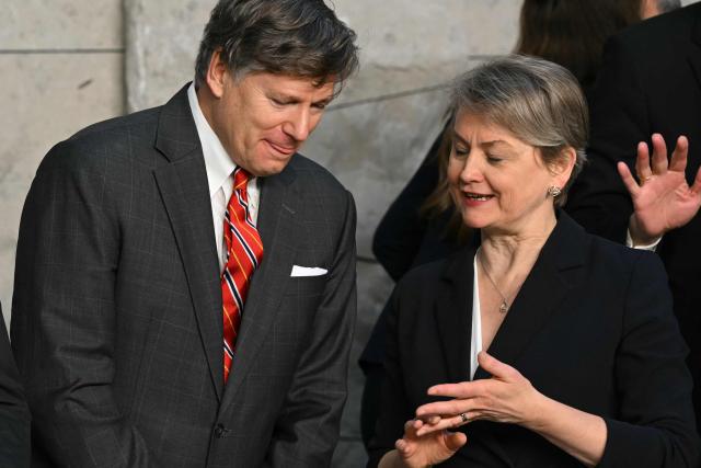 US Deputy Secretary of State Christopher Landau (L) speaks with Britain's Foreign Secretary Yvette Cooper as they prepare for a group photo following a meeting of NATO Ministers of Foreign Affairs at NATO headquarters in Brussels on December 3, 2025. (Photo by NICOLAS TUCAT / AFP)