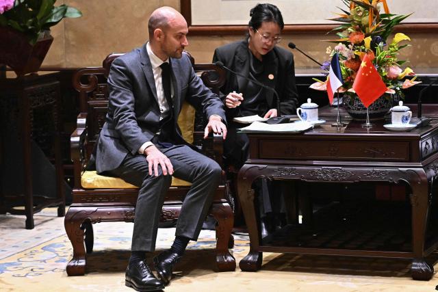France's Foreign Affairs Minister Jean-Noel Barrot (L) attends a meeting with China's Foreign Minister Wang Yi (not pictured) at the Diaoyutai State Guesthouse in Beijing on December 3, 2025. French President Emmanuel Macron touched down on December 3 in China, an AFP journalist saw, where he is expected to put pressure on his counterpart Xi Jinping to help secure a ceasefire in Ukraine and discuss trade relations. (Photo by Pedro PARDO and Pedro Pardo / POOL / AFP)