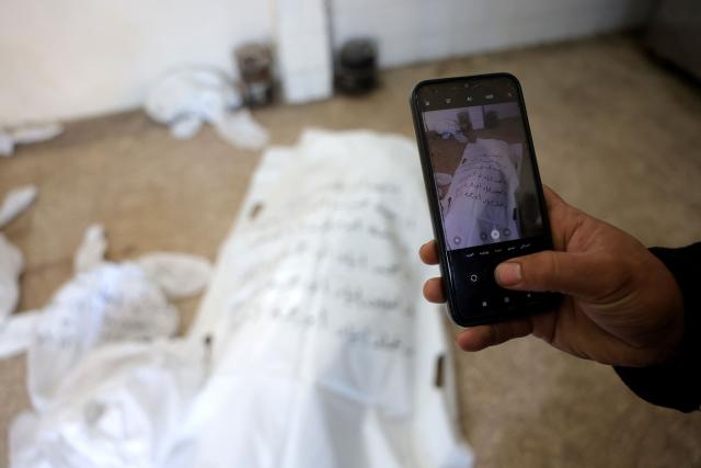 A labelled body bag containing the remains of identified Palestinians killed during Israel-Gaza war, waits to be collected at the morgue of the Al-Aqsa Hospital in Deir al-Balah, in the central Gaza Strip, on December 3, 2025. The war was sparked by Hamas militant's October 7, 2023 attack on Israel, which resulted in the deaths of 1,221 people. Israel's retaliatory assault on Gaza has killed at least 69,733 people, according to figures from the health ministry that the UN considers reliable. (Photo by Bashar Taleb / AFP)