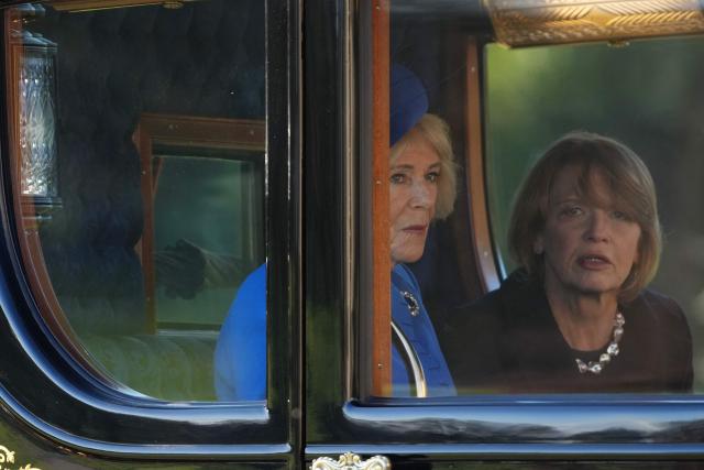 Britain's Queen Camilla (L) and Wife of Germany's President Elke Buedenbender travel by horse-drawn carriage for a Ceremonial Welcome at Windsor Castle in Windsor, on December 3, 2025, the first day of a three day state visit by the German President. (Photo by CARLOS JASSO / POOL / AFP)