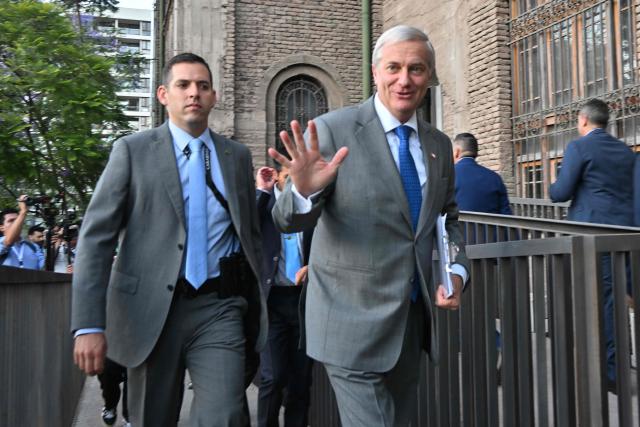 Chile's presidential candidate Jose Antonio Kast, of the Partido Republicano party, waves upon his arrival for a debate organised by the Chilean Radio Association (Archi) in Santiago, on December 3, 2025. The clock is ticking down to a presidential run-off election on December 14, with far-right candidate Jose Antonio Kast the frontrunner to win the second round of voting against leftist Jeannette Jara. (Photo by RODRIGO ARANGUA / AFP)
