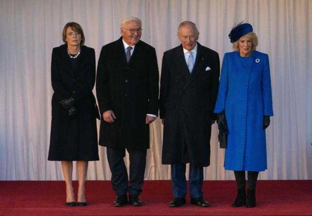 Wife of Germany's President Elke Buedenbender (L), Germany's President Frank-Walter Steinmeier (2L), Britain's King Charles III and Britain's Queen Camilla (R) stand as they watch a military procession during the ceremonial welcome  in the Quadrangle at Windsor Castle in Windsor, on December 3, 2025, the first day of a three day state visit by the German President. (Photo by Carl Court / POOL / AFP)