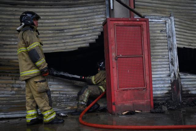 Firefighters try to control a fire at the Rio de Janeiro State Food Distribution Center (CEASA) at Iraja neighborhood in Rio de Janeiro, Brazil on December 3, 2025. (Photo by MAURO PIMENTEL / AFP)