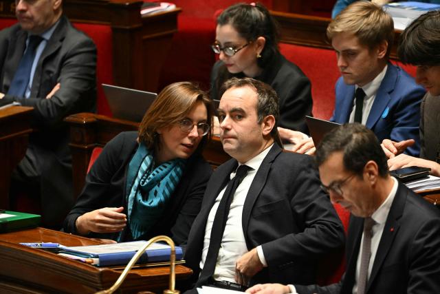 France's Prime Minister Sebastien Lecornu and France's Public Accounts Minister Amelie de Montchalin talk during a session devoted to the second reading of the 2026 social security budget bill (PLFSS) at the National Assembly, the French Parliament lower house, in Paris on December 3, 2025. (Photo by Bertrand GUAY / AFP)