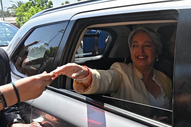 Chile's presidential candidate Jeannette Jara of the Unidad por Chile coalition, shakes hands a supporter as she leaves after a debate organised by the Chilean Radio Association (Archi) in Santiago, on December 3, 2025. The clock is ticking down to a presidential run-off election on December 14, with far-right candidate Jose Antonio Kast the frontrunner to win the second round of voting against leftist Jeannette Jara. (Photo by RODRIGO ARANGUA / AFP)