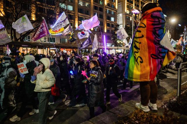 Protesters attend a rally marking the first anniversary of South Korean ousted president Yoon's declaration of martial law, near the National Assembly in Seoul on December 3, 2025. (Photo by ANTHONY WALLACE / AFP)