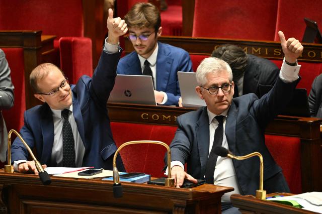 Horizons & Independants' MP and president of the committee on social affairs Frederic Valletoux (R) and Droite Republicaine's MP and rapporteur for the committee on social affairs Thibault Bazin react during a session devoted to the second reading of the 2026 social security budget bill (PLFSS) at the National Assembly, the French Parliament lower house, in Paris on December 3, 2025. (Photo by Bertrand GUAY / AFP)