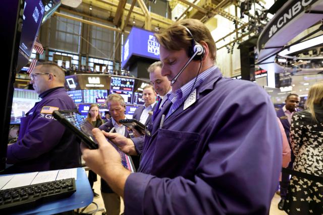 Traders work on the floor of the New York Stock Exchange (NYSE) at the opening bell in New York on December 3, 2025.  (Photo by TIMOTHY A. CLARY / AFP)