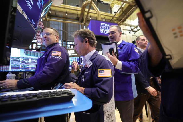 Traders work on the floor of the New York Stock Exchange (NYSE) at the opening bell in New York on December 3, 2025.  (Photo by TIMOTHY A. CLARY / AFP)