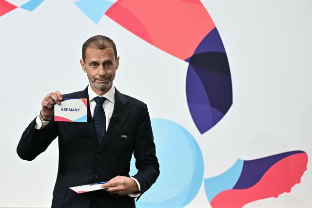 UEFA president Aleksander Ceferin shows the name of Germany, elected to host the UEFA Women's EURO 2029 fooball tournament during an announcement ceremony at the UEFA headquarters, the House of European Football, in Nyon on December 3, 2025.  (Photo by Fabrice COFFRINI / AFP)