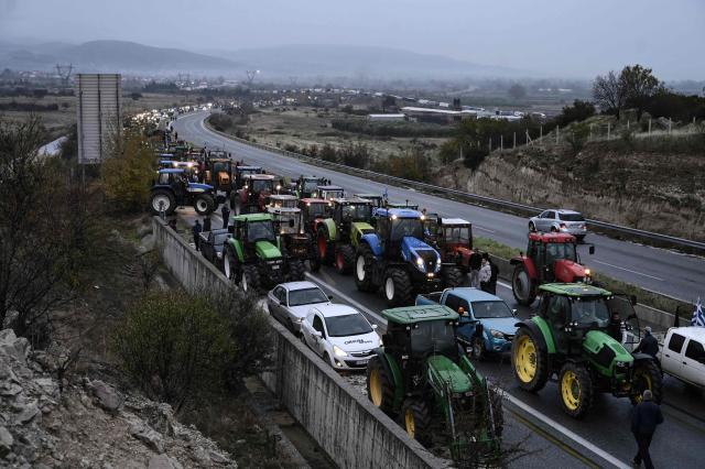 Farmers gather with their tractors during a protest to block the road leading to the customs of Promachonas, in the border of Greece-Boulgaria, over the reduced and delayed payment of European Union subsidies, at the Malgara tolls near Thessaloniki on December 3, 2025. (Photo by SAKIS MITROLIDIS / AFP)