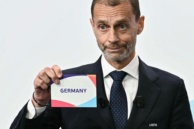 UEFA president Aleksander Ceferin shows the name of Germany, elected to host the UEFA Women's EURO 2029 fooball tournament during an announcement ceremony at the UEFA headquarters, the House of European Football, in Nyon on December 3, 2025.  (Photo by Fabrice COFFRINI / AFP)