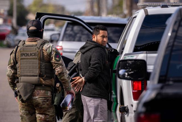 A person is detained by US Customs and Border Patrol (CBP) and other federal law enforcement agents in New Orleans, Louisiana, on December 3, 2025. The US Department of Homeland Security announced on Wednesday it has launched a federal immigration enforcement operation, named "Operation Catahoula Crunch," in the New Orleans, Louisiana, area. (Photo by Adam GRAY / AFP)