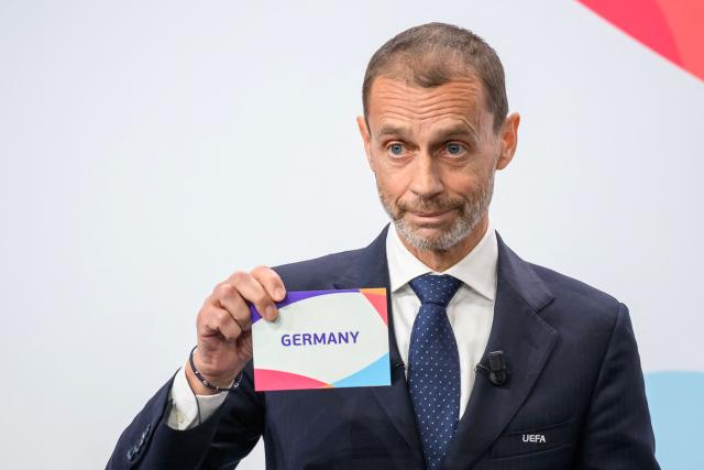 UEFA president Aleksander Ceferin shows the name of Germany, elected to host the UEFA Women's EURO 2029 fooball tournament during an announcement ceremony at the UEFA headquarters, the House of European Football, in Nyon on December 3, 2025. European football's governing body UEFA announced on December 3, 2025 that Germany will host the women's 2029 European Championships, where England will be the two-time defending champions. (Photo by Fabrice COFFRINI / AFP)