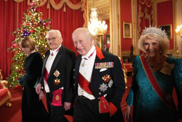 Britain's King Charles III (2R) and his wife Britain's Queen Camilla (R) walk with Germany's President Frank-Walter Steinmeier (C) and his wife Elke Buedenbender as they arrive to attend a State Banquet at Windsor Castle in Windsor, on December 3, 2025, the first day of a three day state visit by the German President. President Frank-Walter Steinmeier received a ceremonial welcome to Britain Wednesday as his state visit got into full swing -- the first by Germany's official head of state in 27 years. (Photo by CARLOS JASSO / POOL / AFP)