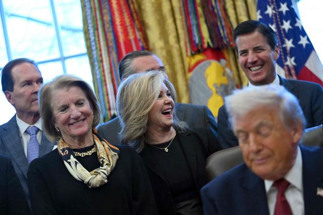 US Senator Marsha Blackburn (C), Republican of Tennessee, reacts as President Donald Trump makes an announcement from the Oval Office of the White House in Washington, DC on December 3, 2025. President Trump announced weaker fuel efficiency standards for the country, as part of his agenda to lower the price of gasoline-powered cars. (Photo by ANDREW CABALLERO-REYNOLDS / AFP)