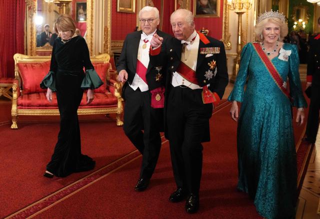 Britain's King Charles III (2R) and his wife Britain's Queen Camilla (R) walk with Germany's President Frank-Walter Steinmeier (C) and his wife Elke Buedenbender as they arrive to attend a State Banquet at Windsor Castle in Windsor, on December 3, 2025, the first day of a three day state visit by the German President. President Frank-Walter Steinmeier received a ceremonial welcome to Britain Wednesday as his state visit got into full swing -- the first by Germany's official head of state in 27 years. (Photo by CARLOS JASSO / POOL / AFP)