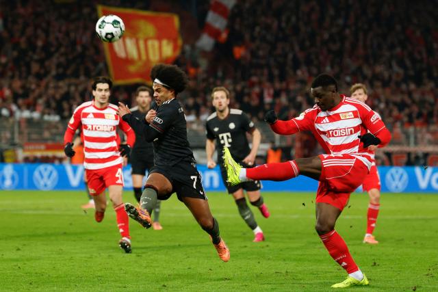 Bayern Munich's German forward #07 Serge Gnabry (L) and Union Berlin's French defender #34 Stanley Nsoki vie for the ball during the German Cup (DFB-Pokal) round of 16 football match between 1 FC Union Berlin and FC Bayern Munich in Berlin on December 3, 2025. (Photo by Odd ANDERSEN / AFP) / DFB REGULATIONS PROHIBIT ANY USE OF PHOTOGRAPHS AS IMAGE SEQUENCES AND QUASI-VIDEO.