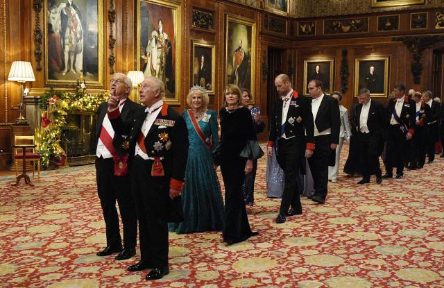 Germany's President Frank-Walter Steinmeier and Britain's King Charles III, followied by Britain's Queen Camilla and Elke Buedenbender and then Britain's Catherine, Princess of Wales and Britain's Prince William, Prince of Wales lead guests as they arrive to attend a State Banquet at Windsor Castle in Windsor, on December 3, 2025, the first day of a three day state visit by the German President. President Frank-Walter Steinmeier received a ceremonial welcome to Britain Wednesday as his state visit got into full swing -- the first by Germany's official head of state in 27 years. (Photo by Aaron Chown / POOL / AFP)