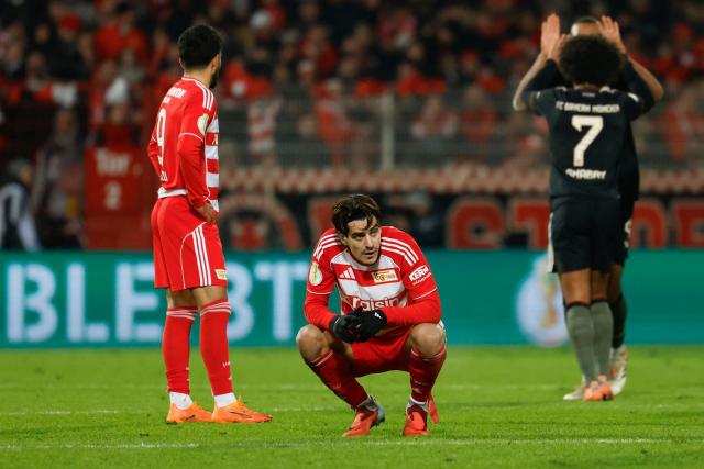 Union Berlin's Portuguese defender #04 Diogo Leite (C) reacts after the German Cup (DFB-Pokal) round of 16 football match between 1 FC Union Berlin and FC Bayern Munich in Berlin on December 3, 2025. Harry Kane scored a first-half header as Bayern Munich did just enough to reach the German Cup quarter-finals in a 3-2 win at Union Berlin on Wednesday. (Photo by Odd ANDERSEN / AFP) / DFB REGULATIONS PROHIBIT ANY USE OF PHOTOGRAPHS AS IMAGE SEQUENCES AND QUASI-VIDEO.