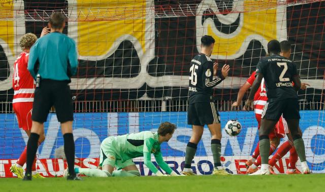 Union Berlin's Danish goalkeeper #01 Frederik Ronnow (3L) reacts as Union Berlin's German forward #10 Ilyas Ansah (not pictured) scores an own goal during the German Cup (DFB-Pokal) round of 16 football match between 1 FC Union Berlin and FC Bayern Munich in Berlin on December 3, 2025. (Photo by Odd ANDERSEN / AFP) / DFB REGULATIONS PROHIBIT ANY USE OF PHOTOGRAPHS AS IMAGE SEQUENCES AND QUASI-VIDEO.