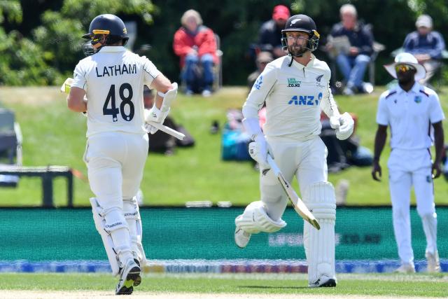 New Zealand's Devon Conway (R) and Tom Latham run between the wickets during day three of the first Test cricket match between New Zealand and West Indies at Hagley Oval in Christchurch on December 4, 2025. (Photo by Sanka Vidanagama / AFP)
