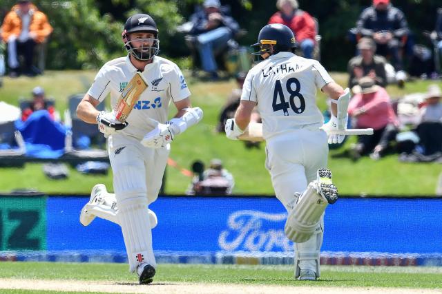 New Zealand's Kane Williamson (L) and Tom Latham run between the wickets during day three of the first Test cricket match between New Zealand and West Indies at Hagley Oval in Christchurch on December 4, 2025. (Photo by Sanka Vidanagama / AFP)
