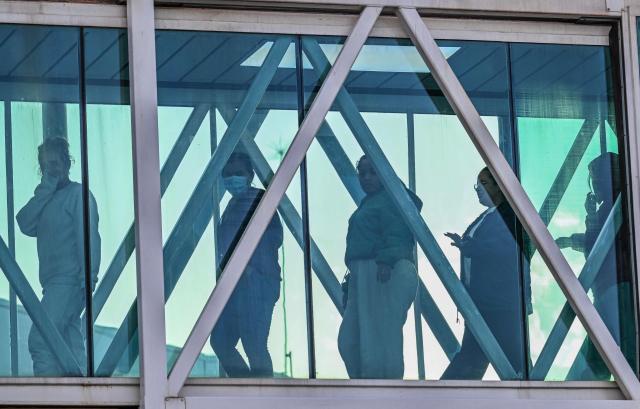 Venezuelan migrants walk after their arrival on an Eastern Airlines plane from the US at Simon Bolivar International Airport in Maiquetia, Venezuela, on December 3, 2025. Venezuela announced on December 2, 2025, that it had reauthorized flights carrying migrants deported by the US, days after suspending them due to President Donald Trump's demand that Venezuelan airspace be considered "closed." (Photo by Juan BARRETO / AFP)