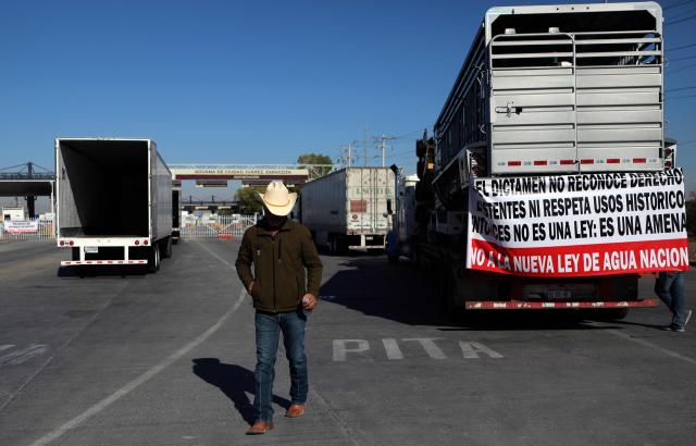 Farmers opposing Mexico's new water law block the commercial crossing into the United States at the Jeronimo-Santa Teresa International Bridge in Ciudad Juarez, Chihuahua state, Mexico, on December 3, 2025. Farmers from several states across the country protest against the approval of the national water law currently being debated in the Mexican Congress. (Photo by Herika Martinez / AFP)