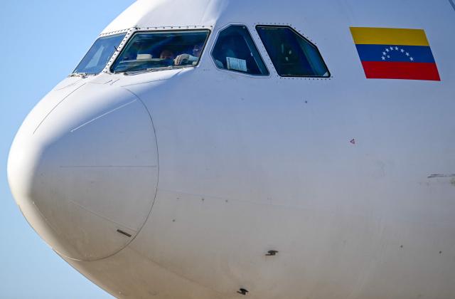 A Conviasa Airlines plane taxis after landing at Simon Bolivar International Airport in Maiquetia, Venezuela, on December 3, 2025. Venezuela announced on December 2, 2025, that it had reauthorized flights carrying migrants deported by the US, days after suspending them due to President Donald Trump's demand that Venezuelan airspace be considered "closed." (Photo by Juan BARRETO / AFP)