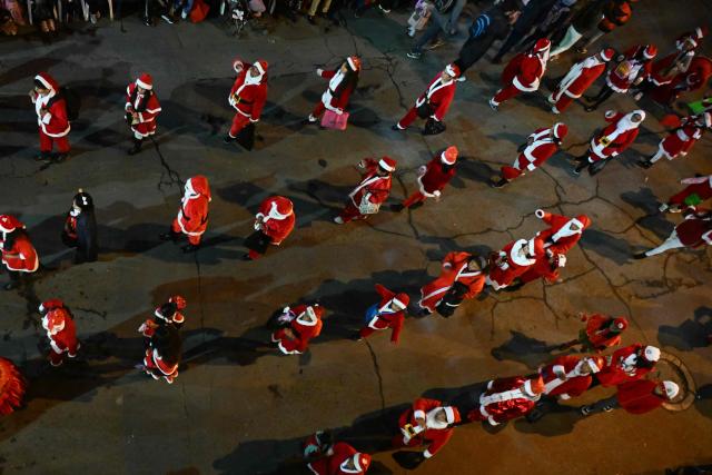 Merchants from the seat of government take part in the annual Christmas parade marking the start of the festive season in La Paz, December 3, 2025. (Photo by Aizar RALDES / AFP)