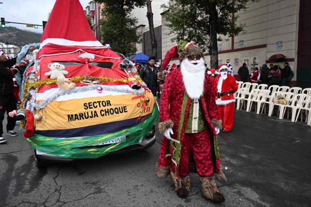 A man dressed as Santa Claus walks in the annual Christmas parade marking the start of the festive season in La Paz December 3, 2025. (Photo by Aizar RALDES / AFP)