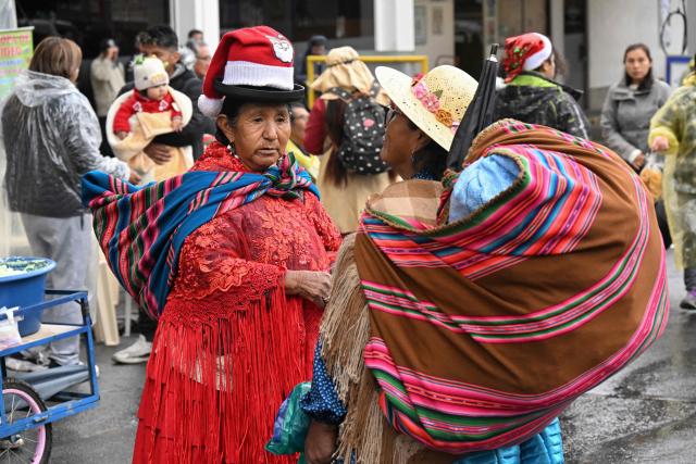 Bolivian Aymara women take part in the annual Christmas parade marking the start of the festive season in La Paz December 3, 2025 (Photo by Aizar RALDES / AFP)