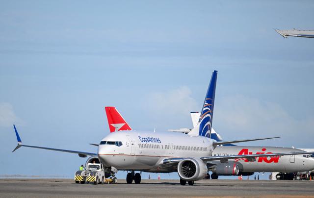 A Copa Airlines plane is pictured at Simon Bolivar International Airport in Maiquetia, Venezuela, on December 3, 2025. Venezuela announced on December 2, 2025, that it had reauthorized flights carrying migrants deported by the US, days after suspending them due to President Donald Trump's demand that Venezuelan airspace be considered "closed." (Photo by Juan BARRETO / AFP)
