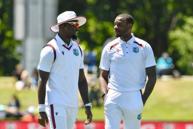 West Indies' Justin Greaves (R) talks with Jayden Seales during day three of the first Test cricket match between New Zealand and West Indies at Hagley Oval in Christchurch on December 4, 2025. (Photo by Sanka Vidanagama / AFP)