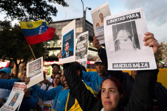Venezuelan citizens attend a candlelight vigil against Venezuela's President Nicolas Maduro and in support of US President Donald Trump at Lourdes Park in Bogota on December 3, 2025. Venezuela's President Nicolas Maduro confirmed on December 3, 2025, that he had a "cordial" phone call with his US counterpart Donald Trump 10 days ago amid a US military buildup in Latin America. (Photo by Luis ACOSTA / AFP)