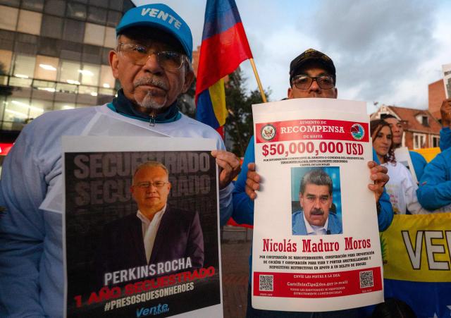 Venezuelan citizens attend a candlelight vigil against Venezuela's President Nicolas Maduro and in support of US President Donald Trump at Lourdes Park in Bogota on December 3, 2025. Venezuela's President Nicolas Maduro confirmed on December 3, 2025, that he had a "cordial" phone call with his US counterpart Donald Trump 10 days ago amid a US military buildup in Latin America. (Photo by Luis ACOSTA / AFP)