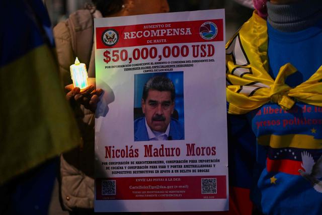 A Venezuelan citizen holds a candlelight during a vigil against Venezuela's President Nicolas Maduro and in support of US President Donald Trump at Lourdes Park in Bogota on December 3, 2025. Venezuela's President Nicolas Maduro confirmed on December 3, 2025, that he had a "cordial" phone call with his US counterpart Donald Trump 10 days ago amid a US military buildup in Latin America. (Photo by Luis ACOSTA / AFP)